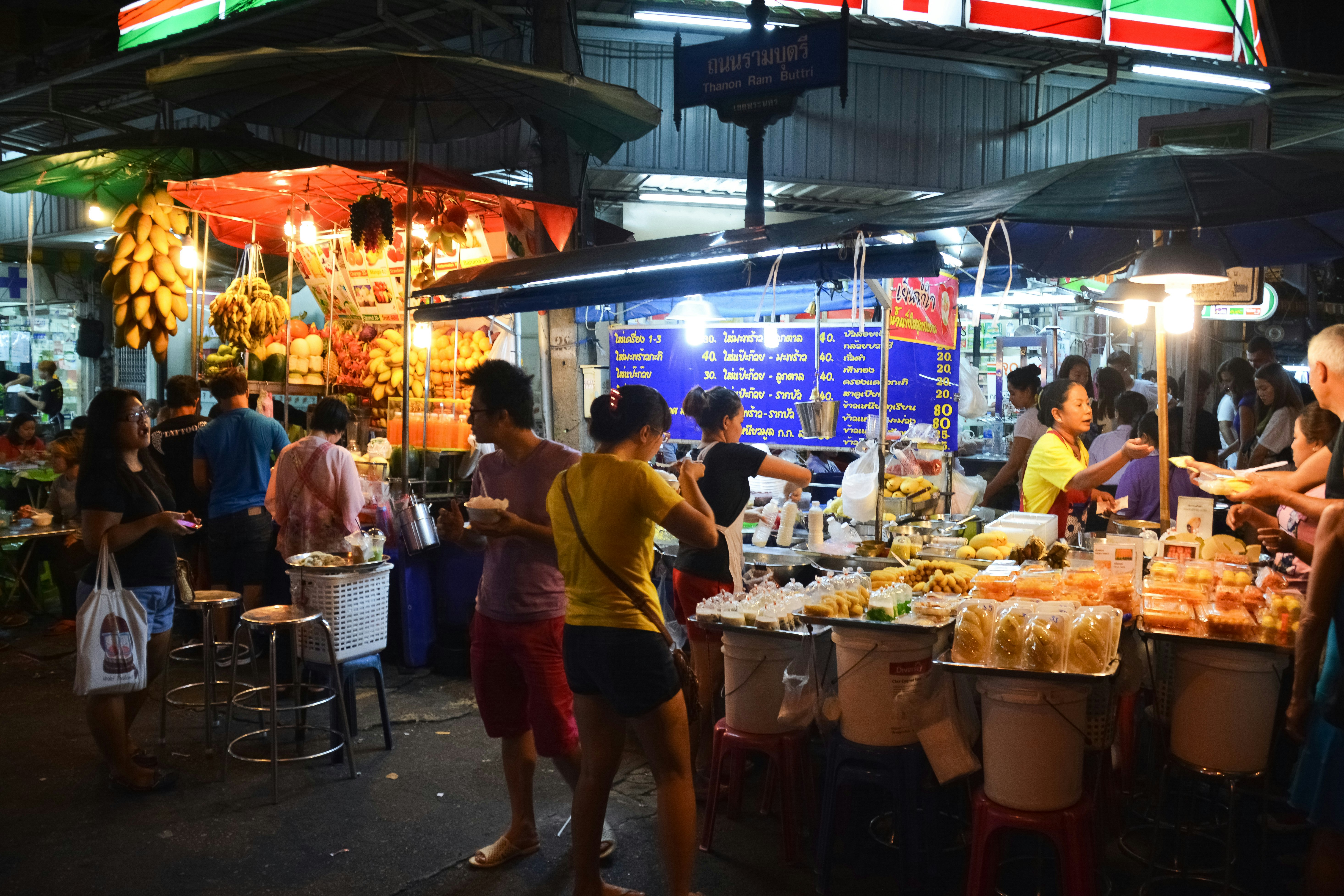 people standing in front of food stall during daytime